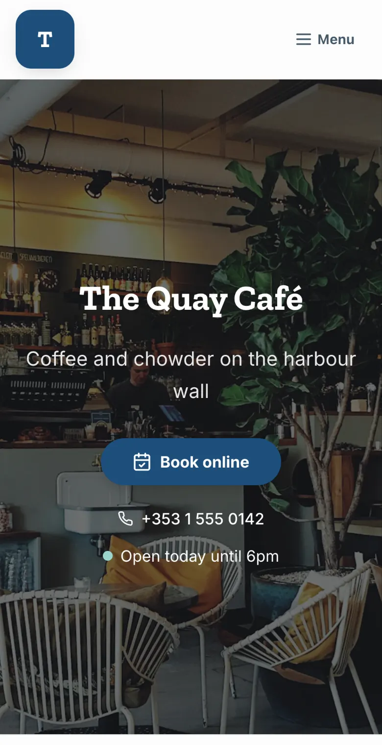 The Quay Café, a demo site, in the Harbour look: navy buttons and a slab-serif name
